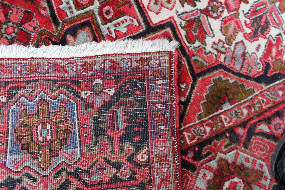 A large red ground rug with a small cent - Image 3 of 4