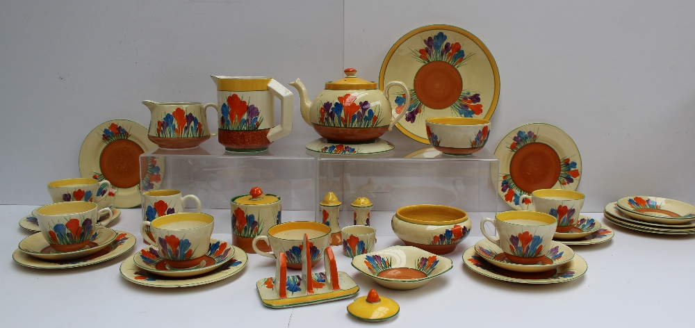 A Clarice Cliff matched crocus pattern part tea and dessert set comprising a teapot and stand, three