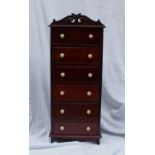 A Miniature chest of drawers with a moul