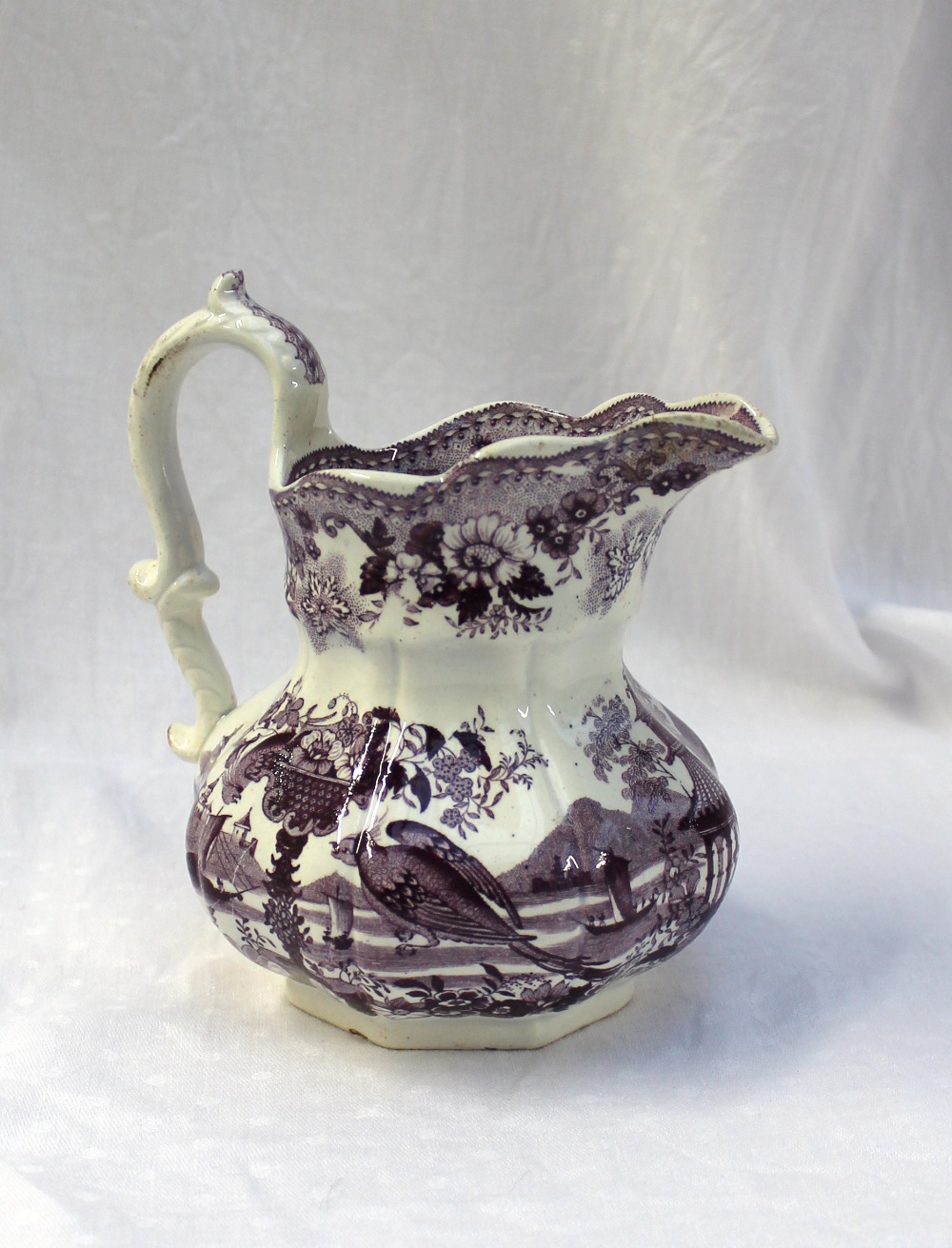 A Swansea pottery pouch jug decorated in the Oriental basket pattern, printed mark, 17cm high