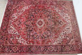 A large red ground rug with a small cent