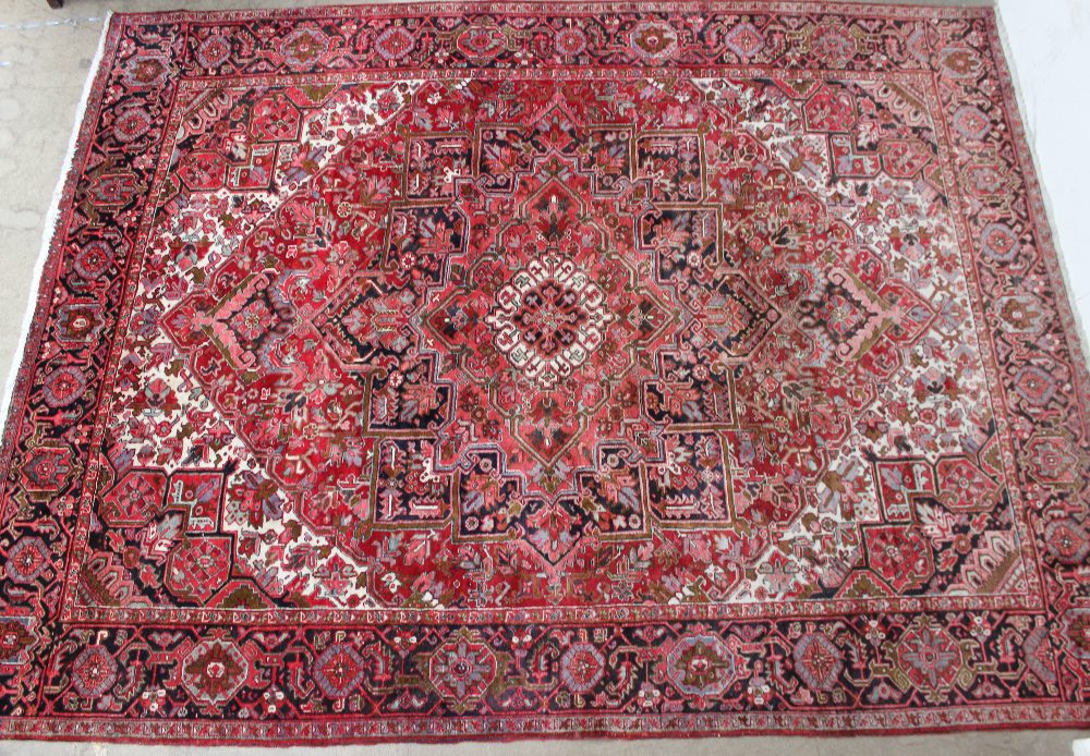 A large red ground rug with a small cent - Image 2 of 4