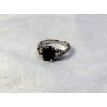 A sapphire and diamond ring set with a c
