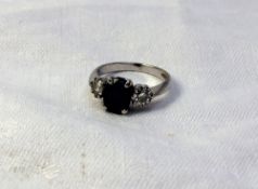 A sapphire and diamond ring set with a c