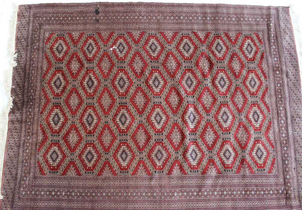 A red ground rug with a central geometri