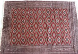 A red ground rug with a central geometri