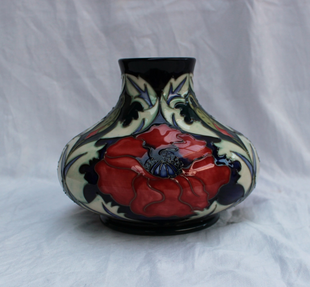 A modern Moorcroft pottery vase of squat form in the poppy design, impressed and painted marks dated