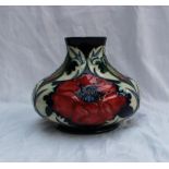 A modern Moorcroft pottery vase of squat form in the poppy design, impressed and painted marks dated