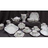 A Shelley part tea set decorated with garden flowers, including a large bowl, plate, teapot,