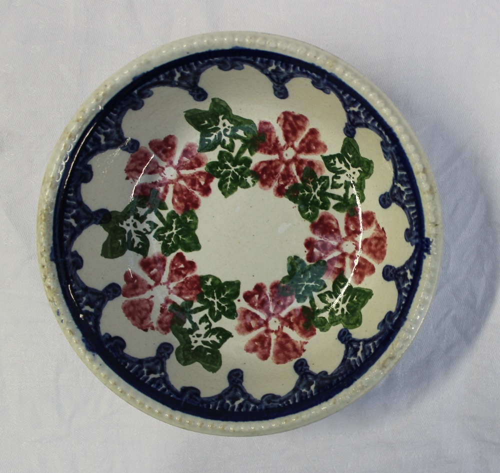 A 19th century spongeware bowl decorated with flowerheads and leaves to a blue swag drop border, - Image 2 of 4