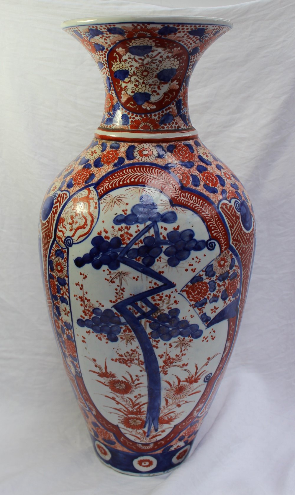 A large 19th century Japanese Imari porcelain baluster vase, decorated with prunus blossom and