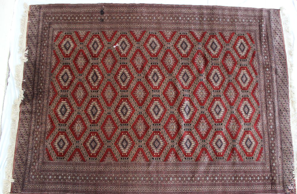 A red ground rug with a central geometri - Image 2 of 6