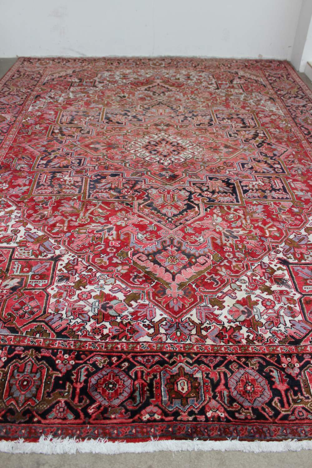 A large red ground rug with a small cent - Image 4 of 4