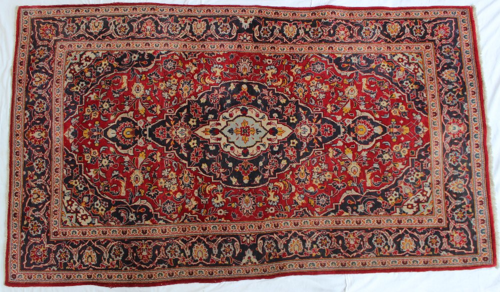 A red ground rug with a central medallio