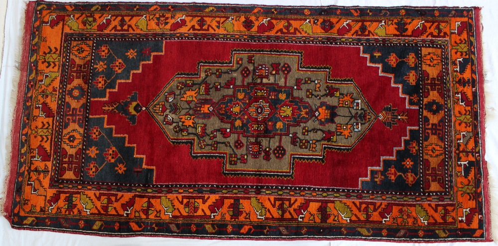 A red ground rug with a central medallio