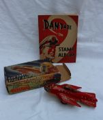 A Mettoy Dan Dare tin plate space ship "Eagle" boxed together with a Dan Dare stamp album  CONDITION