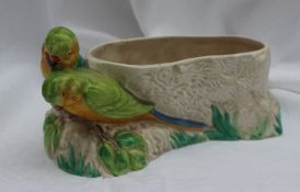 A Clarice Cliff Budgerigar vase, of oval form with two budgerigars on a rocky base, 28cm long