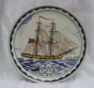 A Poole pottery charger painted with a ship "H.M. Sloop Viper, built at Poole by Tito Durell