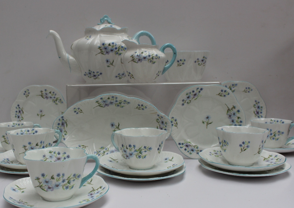 A Shelley part tea set decorated in the Blue Rock pattern No.13591, including a teapot, oval dish,