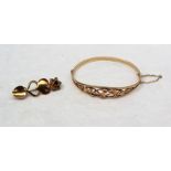 A 9ct yellow Welsh gold hinged bangle decorated with intertwined leaves,