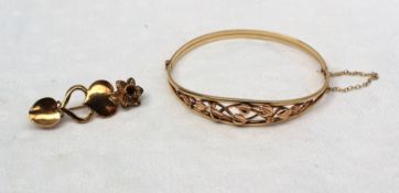 A 9ct yellow Welsh gold hinged bangle decorated with intertwined leaves,