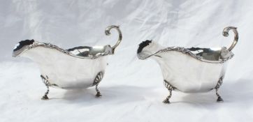 A pair of George V silver sauce boats, with a panelled body,