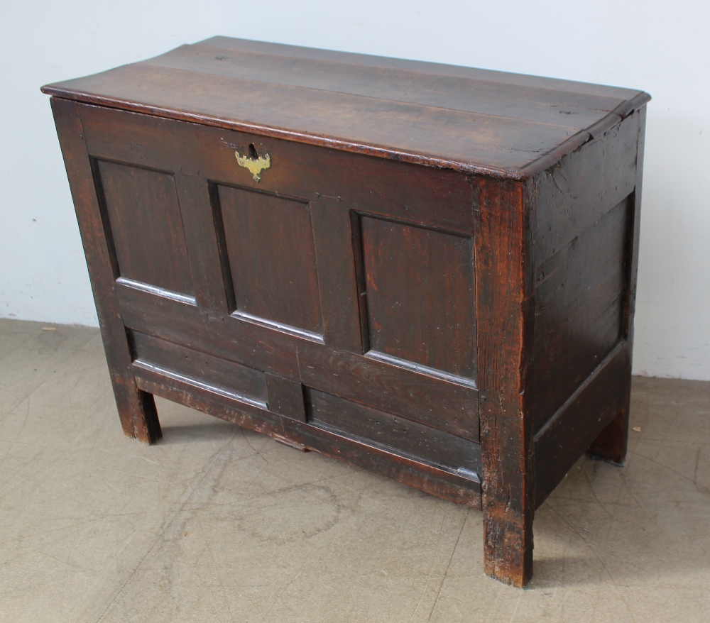 An 18th century oak coffer, the planked rectangular top above a four panel front on stiles, - Image 2 of 5