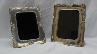 A pair of continental white metal photograph frames,