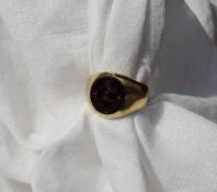 A Gentleman's signet ring with a hardstone seal to a yellow metal shank,