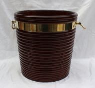 A modern dark mahogany peat bucket in the George III style with a ribbed body brass bandings and