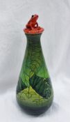 A Dennis China Works pottery trial standard flask in the Rainforest pattern with a red frog seated