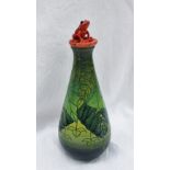 A Dennis China Works pottery trial standard flask in the Rainforest pattern with a red frog seated