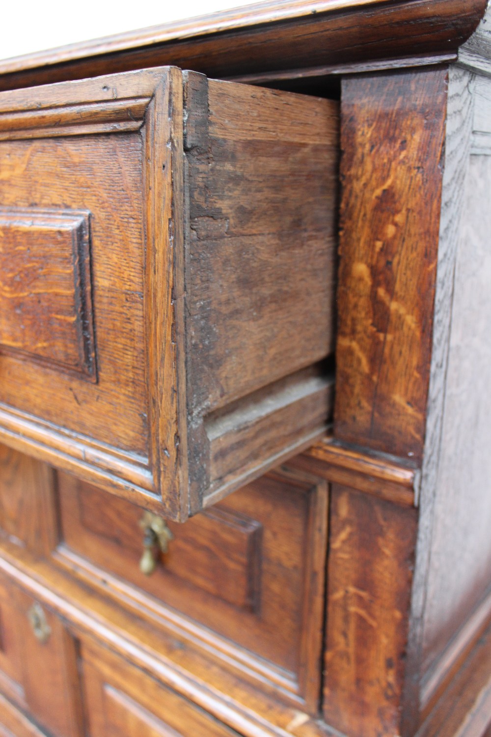A 17th century style oak chest the planked moulded rectangular top above four drawers with geometric - Image 2 of 2