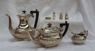 A late Victorian silver three piece tea set, comprising a hot water jug, teapot and cream jug,