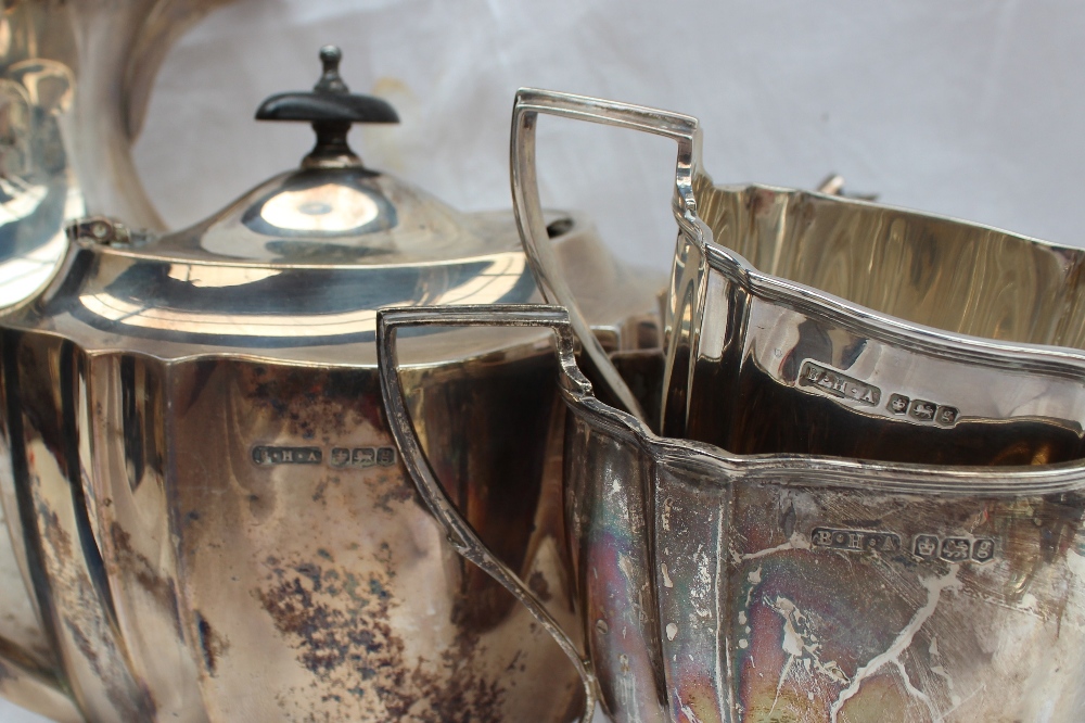 A George V silver four piece tea set of panelled form, comprising a hot water jug, teapot, - Image 3 of 3