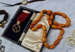 An amber necklace together with a matching bracelet, with cylindrical beads together with a gilt