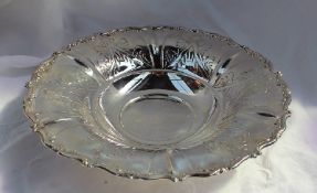 A white metal bowl of circular form with a scrolling edge and leaf engraving, marked 800,