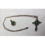 A white metal cross set with turquoise,