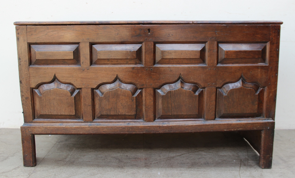 An 18th century oak coffer the planked rectangular top above an eight panel front on stiles, - Image 2 of 4