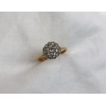 A diamond cluster ring set with nineteen old cut diamonds to a white metal rubbed over setting on a
