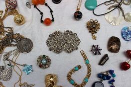 A large quantity of costume jewellery including a nurses belt, bracelets, necklaces, pendants,