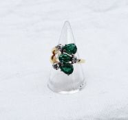 An emerald and diamond ring set with three pear shaped emeralds and three brilliant cut diamonds to