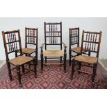 A set of five 19th century spindle back dining chairs with rush seats on tapering cylindrical front