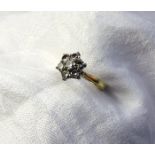 A diamond cluster ring set with a central round brilliant cut diamond approximately 0.