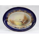 A Royal Worcester porcelain oval dish painted with a mallard and other ducks in flight from a pond