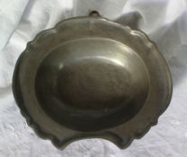 A pewter bleeding bowl with a shaped edge and shallow bowl, 23cm wide x 19.5cm deep CONDITION