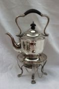A George V silver kettle on stand with a shaped handle and a tapering body,