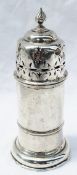 A George V silver sugar caster of cylindrical form with a flame finial and pierced domed lid,