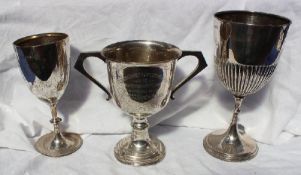 A George V silver twin handled trophy cup with a ring turned column on a spreading foot ,