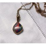 A fire opal mounted in 9ct yellow gold pendant on a 9ct yellow gold chain CONDITION REPORT: